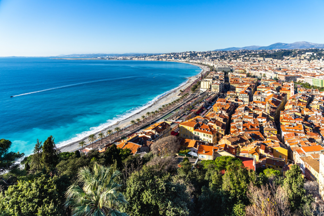 Aerial view of Nice old town with orange rooftops, Promenade des Anglais and turquoise Mediterranean Sea, Cote d'Azur, France