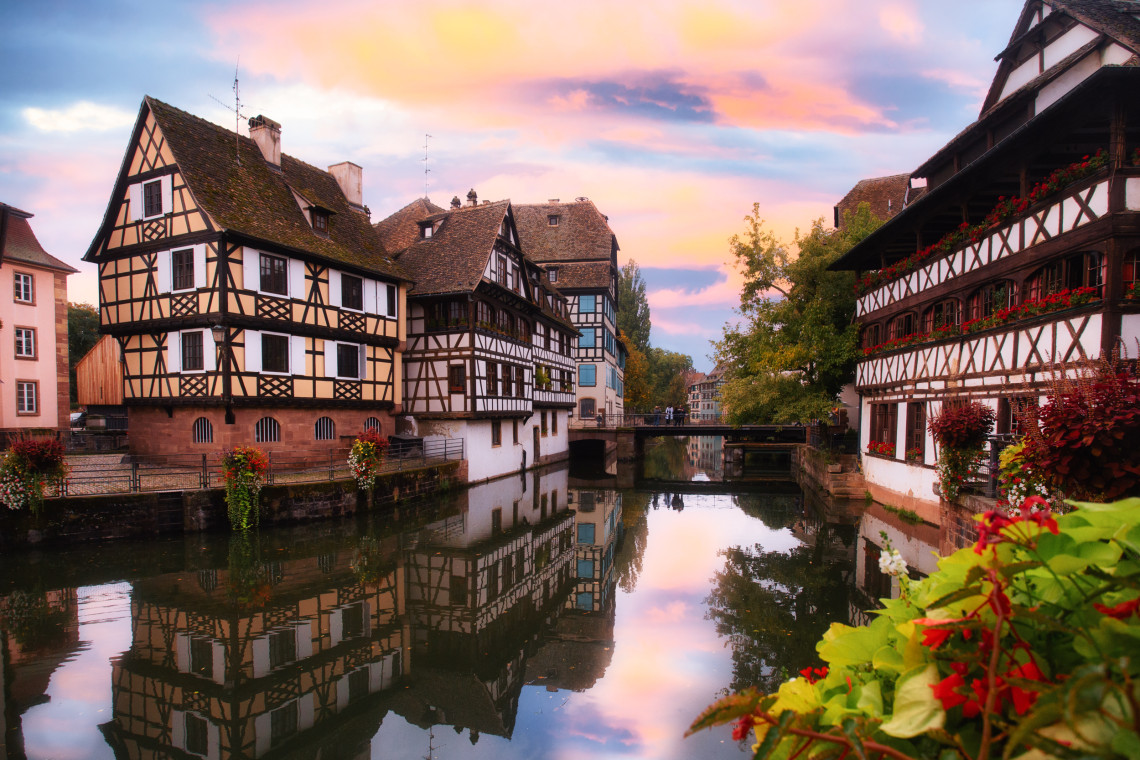 Half-timbered houses reflected in the canal at La Petite France neighborhood at sunset, Strasbourg, Alsace, France
