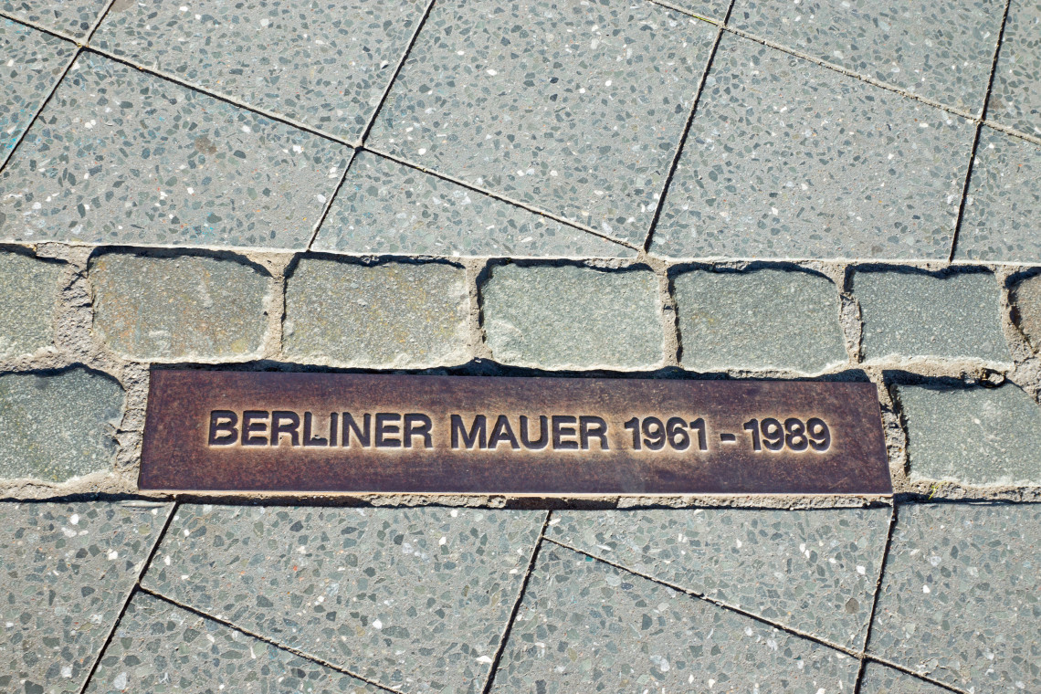 Ground plaque marking the former route of the Berlin Wall, inscribed &ldquo;Berliner Mauer 1961&ndash;1989&rdquo; in the pavement.