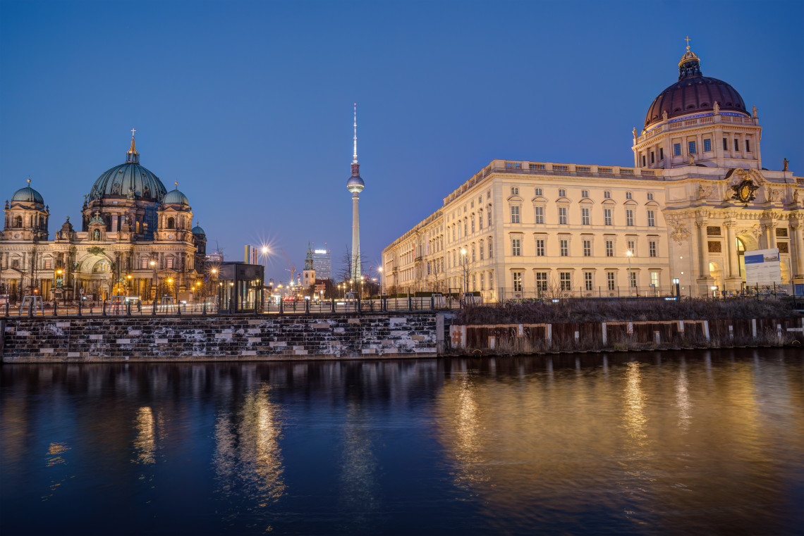 Evening view across the River Spree toward Berlin Cathedral, the Fernsehturm and historic buildings around Museum Island.