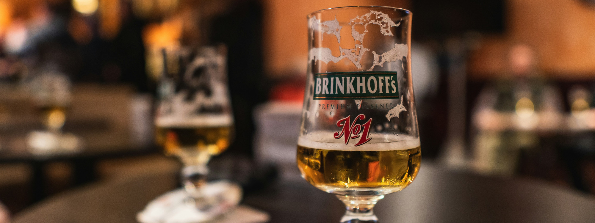 Glass of Brinkhoff’s No. 1 beer served in a German bar, representing Dortmund’s local brewing tradition.