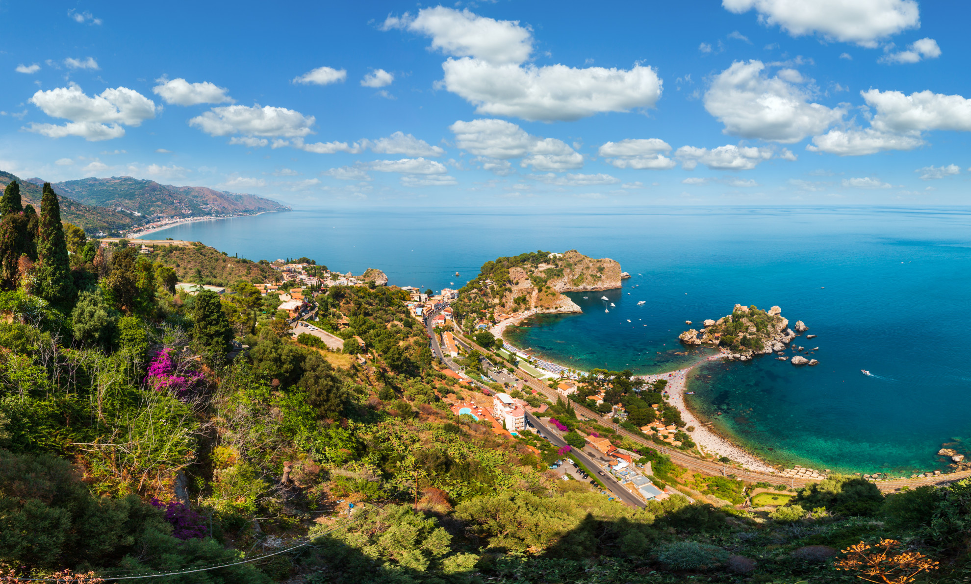 Aerial view of Isola Bella and its sandy beach with turquoise water near Taormina, Sicily, Italy
