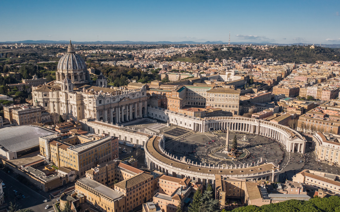 Aerial view of St. Peter's Basilica and St. Peter's Square with Bernini's colonnades and the Vatican Museums complex, Vatican City, Rome, Italy