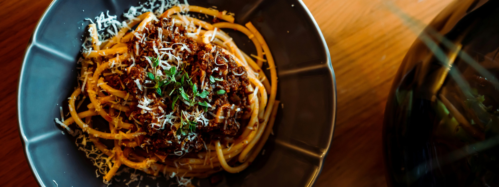Plate of spaghetti bolognese with rich meat sauce and grated parmesan, a classic Italian pasta dish from Bologna