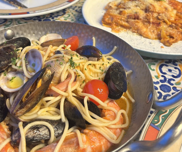 Bowl of spaghetti ai frutti di mare with mussels, clams, shrimp and cherry tomatoes, a classic Italian seafood pasta dish