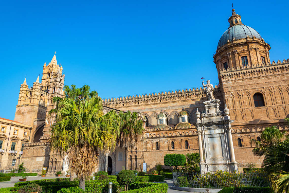 Exterior view of Palermo Cathedral with Arab Norman tower, Baroque dome and palm trees in the foreground, Palermo, Sicily, Italy